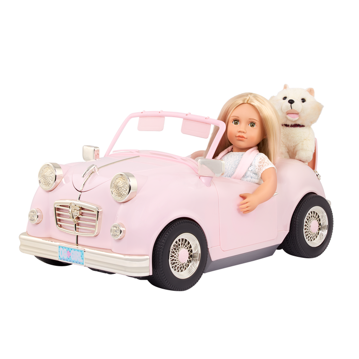 A pink and gold toy convertible car with a 18-inch doll and a stuffed animal inside, designed for play.
